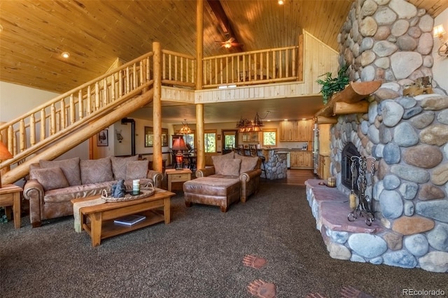 carpeted living room featuring ceiling fan, a stone fireplace, wood ceiling, and high vaulted ceiling