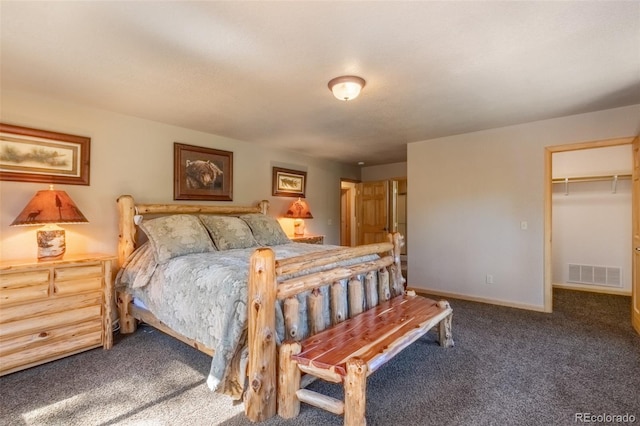 bedroom with carpet flooring, a spacious closet, and a closet