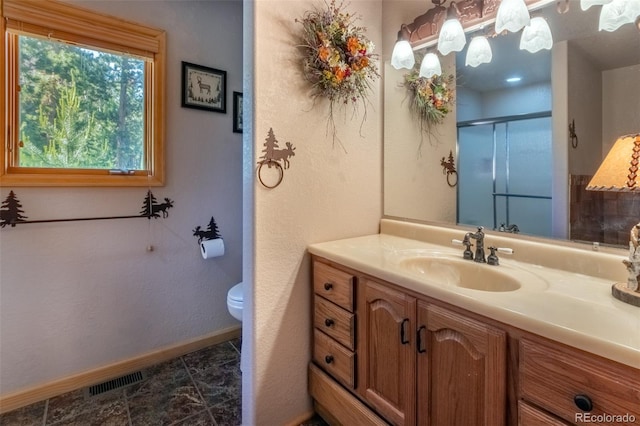 bathroom with vanity, toilet, and walk in shower