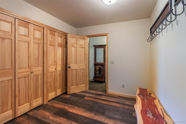 bedroom with dark hardwood / wood-style floors