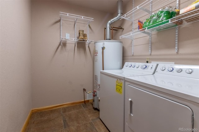 washroom with washer and clothes dryer and water heater