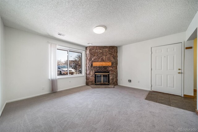 6380 Oak St Unit 107, Arvada, CO 80004 - unfurnished living room featuring carpet flooring, visible vents, a fireplace, and baseboards