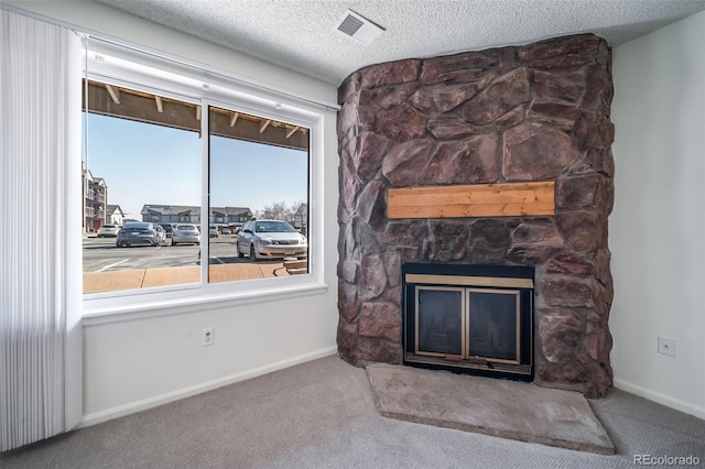 details featuring baseboards, carpet floors, a stone fireplace, and visible vents