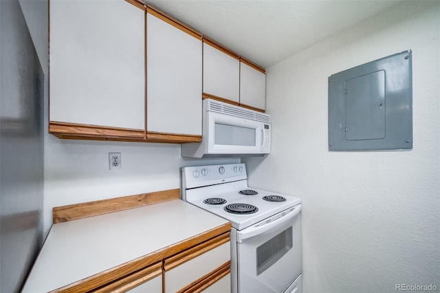 kitchen with electric panel, white cabinetry, white appliances, and light countertops