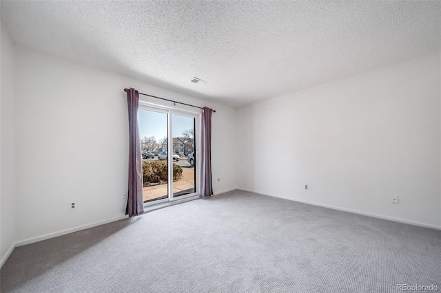 unfurnished room with a textured ceiling, baseboards, visible vents, and carpet floors