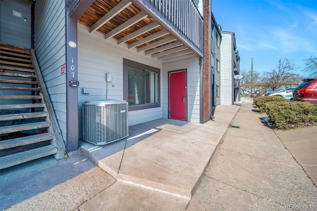 doorway to property featuring central air condition unit