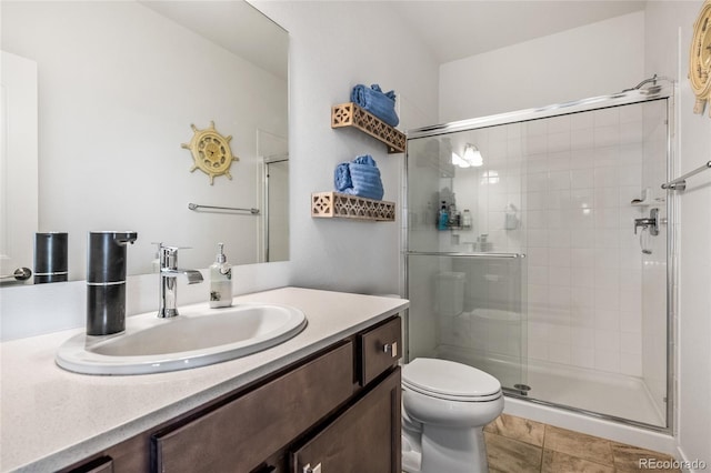 full bathroom with toilet, a shower stall, tile patterned flooring, and vanity