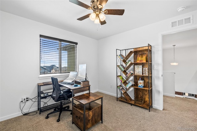 carpeted home office with baseboards, visible vents, and a ceiling fan