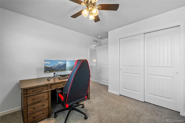 office area with carpet flooring, ceiling fan, visible vents, and baseboards