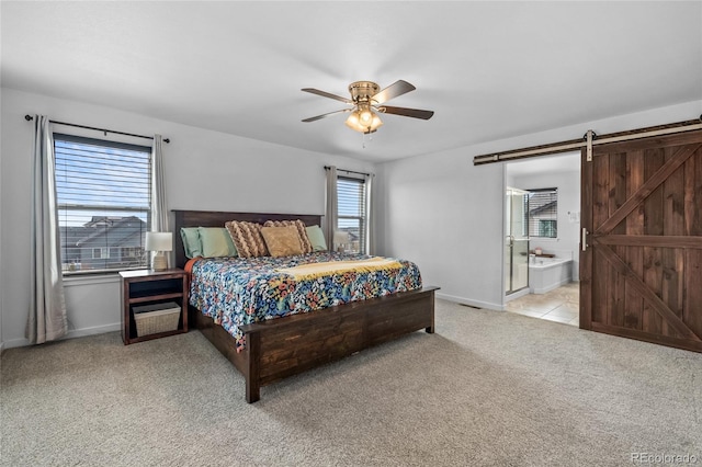 bedroom featuring a barn door, baseboards, ceiling fan, and light colored carpet