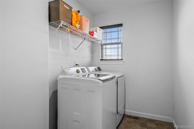 washroom featuring laundry area, independent washer and dryer, and baseboards