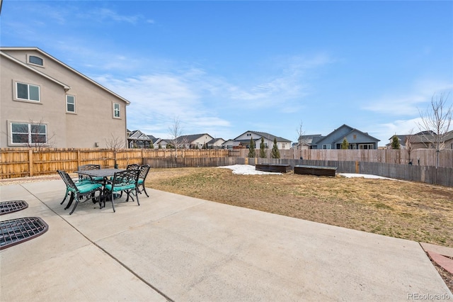 view of patio with a residential view, a fenced backyard, and outdoor dining space