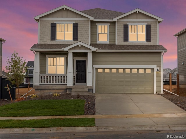 2728 73rd Avenue Ct, Greeley, CO 80634 - view of front of property featuring a porch, a garage, driveway, a shingled roof, and a yard