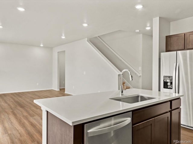 2728 73rd Avenue Ct, Greeley, CO 80634 - kitchen with stainless steel appliances, a sink, a kitchen island with sink, light countertops, and recessed lighting