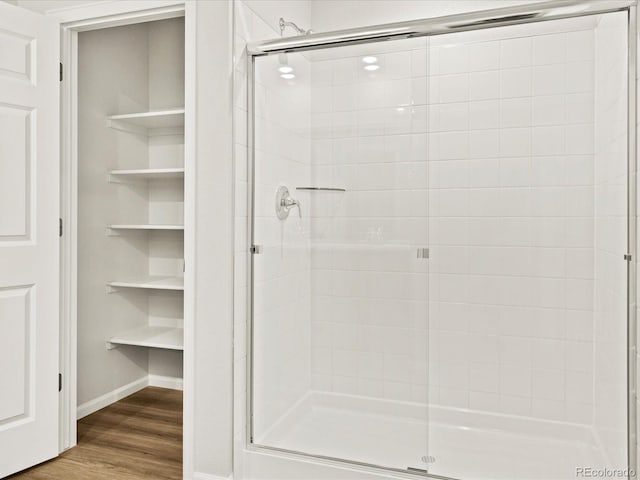 2728 73rd Avenue Ct, Greeley, CO 80634 - full bathroom with a shower stall, wood finished floors, and baseboards
