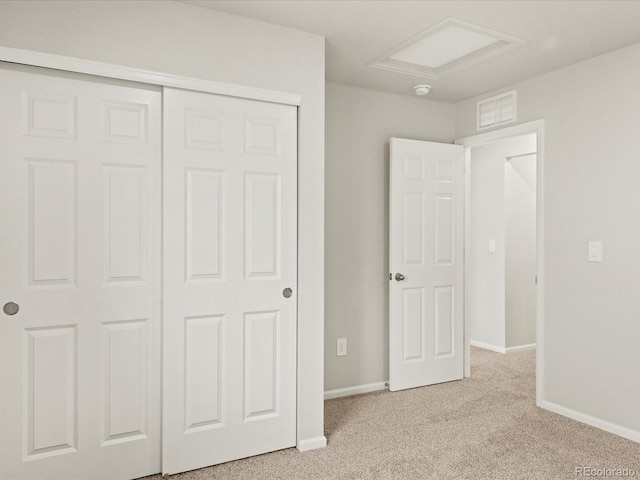 2728 73rd Avenue Ct, Greeley, CO 80634 - unfurnished bedroom featuring light colored carpet, baseboards, a closet, and attic access
