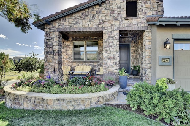 10553 Fairhurst Way, Highlands Ranch, CO 80126 - doorway to property featuring stone siding, covered porch, and stucco siding