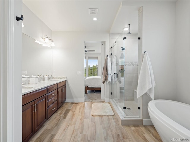 10553 Fairhurst Way, Highlands Ranch, CO 80126 - full bathroom featuring double vanity, a freestanding tub, a stall shower, connected bathroom, and baseboards