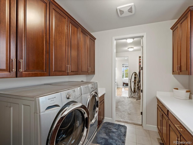 10553 Fairhurst Way, Highlands Ranch, CO 80126 - washroom with washer and clothes dryer, cabinet space, light tile patterned flooring, baseboards, and light carpet