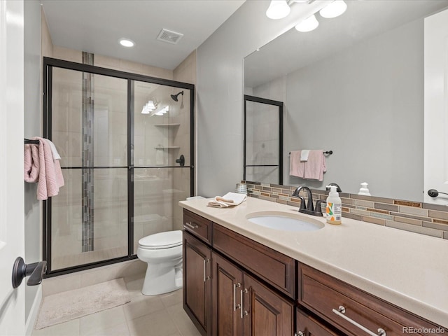 10553 Fairhurst Way, Highlands Ranch, CO 80126 - bathroom with a stall shower, decorative backsplash, tile patterned flooring, and toilet