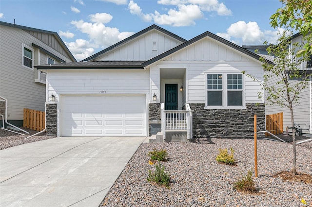 13322 E 110th Way, Commerce City, CO 80022 - view of front of property featuring board and batten siding, stone siding, driveway, and a garage