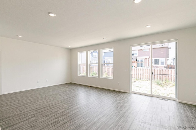 13322 E 110th Way, Commerce City, CO 80022 - empty room featuring wood finished floors, healthy amount of natural light, and recessed lighting