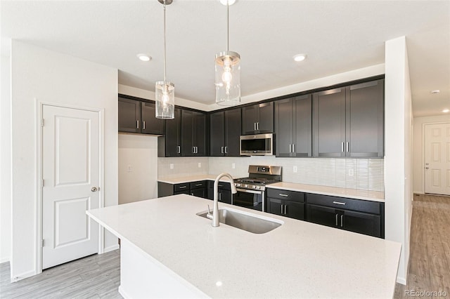 13322 E 110th Way, Commerce City, CO 80022 - kitchen featuring appliances with stainless steel finishes, light countertops, tasteful backsplash, light wood-style flooring, and recessed lighting