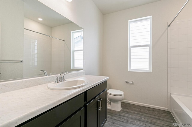 13322 E 110th Way, Commerce City, CO 80022 - full bath featuring vanity, plenty of natural light, wood finished floors, and bathtub / shower combination