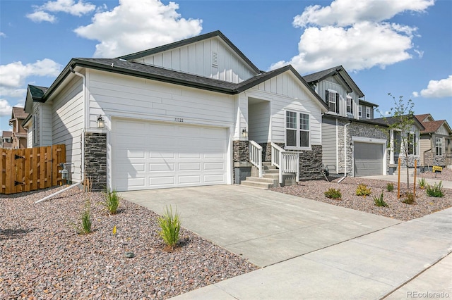 13322 E 110th Way, Commerce City, CO 80022 - view of front of home with board and batten siding, stone siding, driveway, and an attached garage