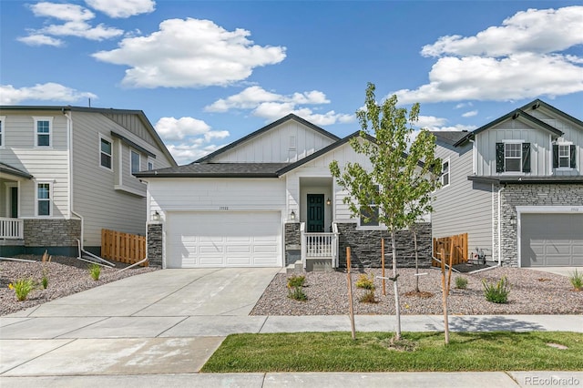 13322 E 110th Way, Commerce City, CO 80022 - view of front of home with board and batten siding, stone siding, concrete driveway, and an attached garage