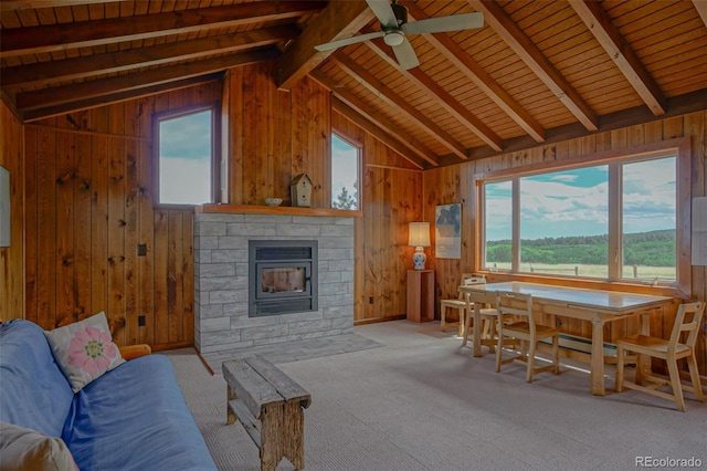 carpeted living room featuring wood ceiling, a fireplace, lofted ceiling with beams, and ceiling fan