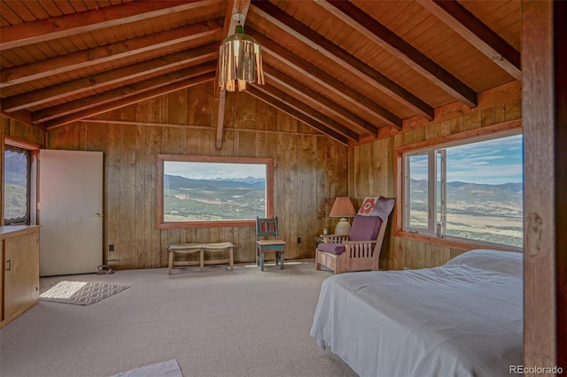 bedroom featuring vaulted ceiling with beams, wooden walls, carpet, and wooden ceiling