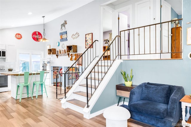 12175 Birch St, Thornton, CO 80241 - stairway featuring wood finished floors and high vaulted ceiling