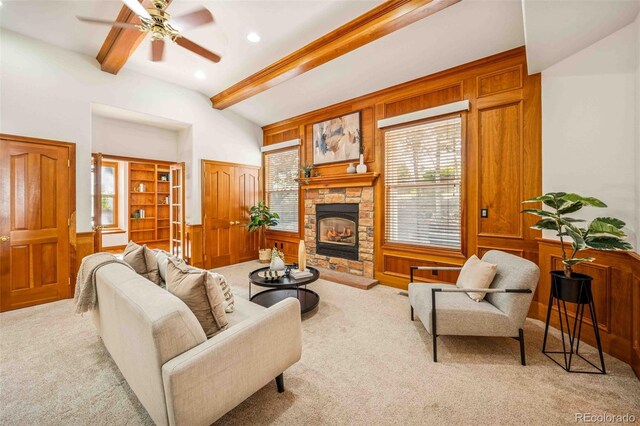 7506 Urban Ct, Arvada, CO 80005 - carpeted living area featuring healthy amount of natural light, a fireplace, ceiling fan, a wainscoted wall, and recessed lighting