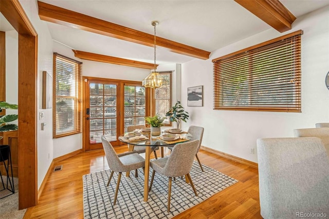 7506 Urban Ct, Arvada, CO 80005 - dining room featuring beam ceiling, a chandelier, and light wood-type flooring