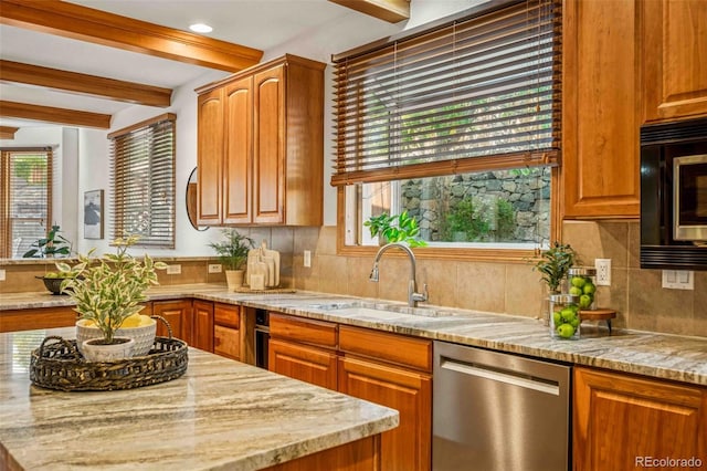 7506 Urban Ct, Arvada, CO 80005 - kitchen featuring appliances with stainless steel finishes, beam ceiling, light stone countertops, tasteful backsplash, and brown cabinetry