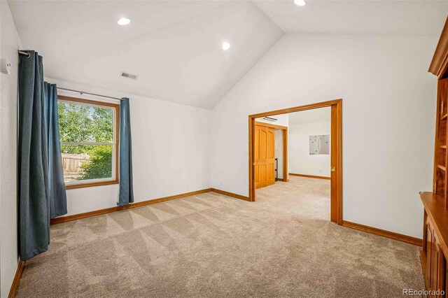 7506 Urban Ct, Arvada, CO 80005 - spare room featuring light carpet, lofted ceiling, and recessed lighting