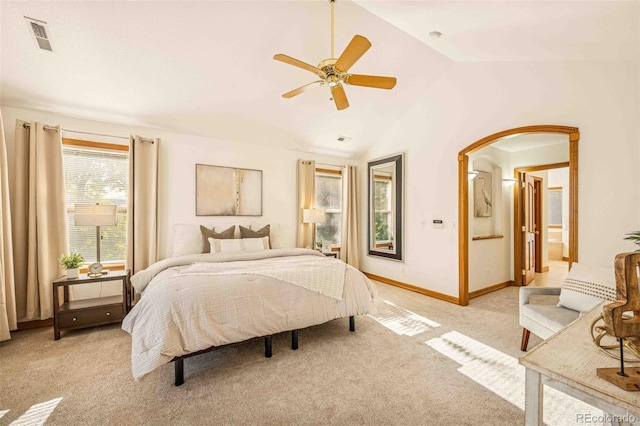 7506 Urban Ct, Arvada, CO 80005 - bedroom featuring vaulted ceiling, light carpet, arched walkways, ceiling fan, and connected bathroom