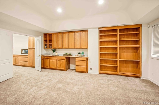 7506 Urban Ct, Arvada, CO 80005 - kitchen featuring open shelves, light colored carpet, light countertops, recessed lighting, and brown cabinets