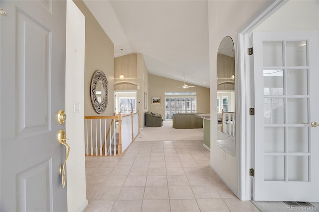 entryway featuring lofted ceiling, ceiling fan, and light tile patterned floors