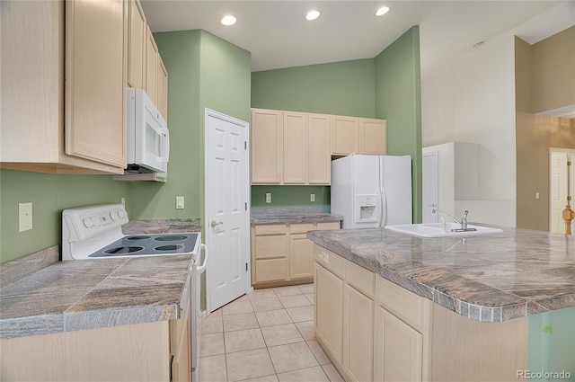 kitchen with light tile patterned floors, tile countertops, white appliances, and a sink