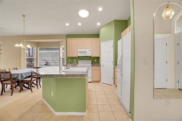 kitchen featuring a chandelier, light tile patterned flooring, a kitchen island with sink, recessed lighting, and white appliances