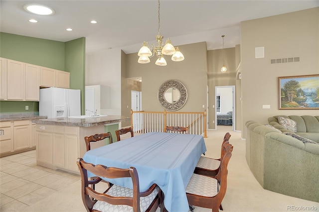 dining room featuring light carpet, visible vents, high vaulted ceiling, and recessed lighting