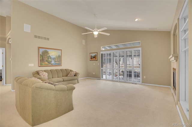 living area featuring light colored carpet, visible vents, a glass covered fireplace, and baseboards