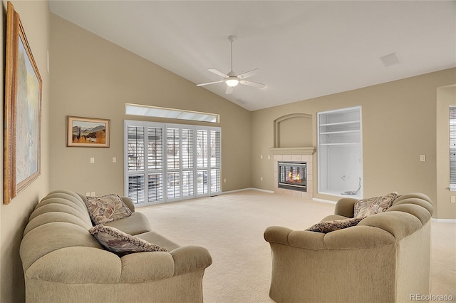 carpeted living room featuring high vaulted ceiling, a tiled fireplace, a ceiling fan, and baseboards