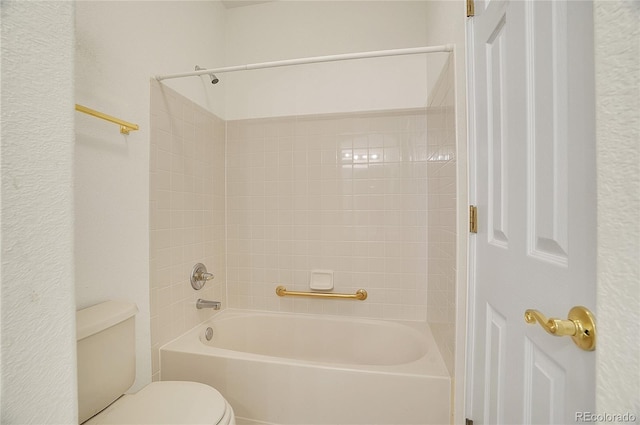 bathroom with bathing tub / shower combination and toilet