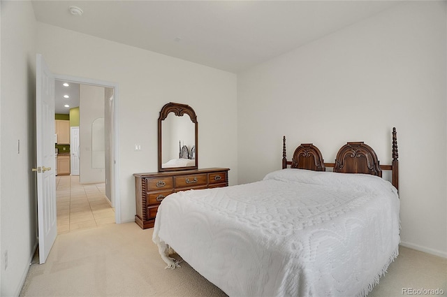 bedroom with light carpet, recessed lighting, and baseboards