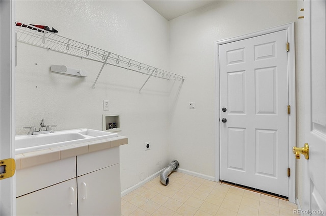 laundry room featuring hookup for a washing machine, hookup for an electric dryer, a sink, baseboards, and cabinet space