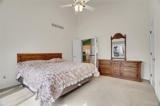 bedroom with baseboards, visible vents, a ceiling fan, carpet flooring, and high vaulted ceiling