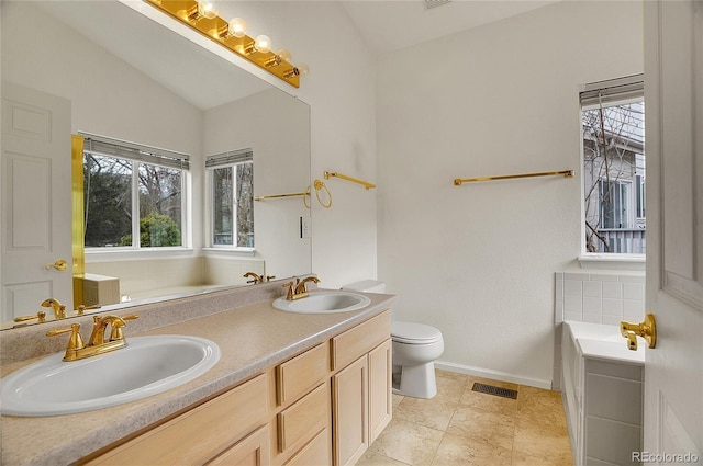 bathroom with plenty of natural light, visible vents, and a sink